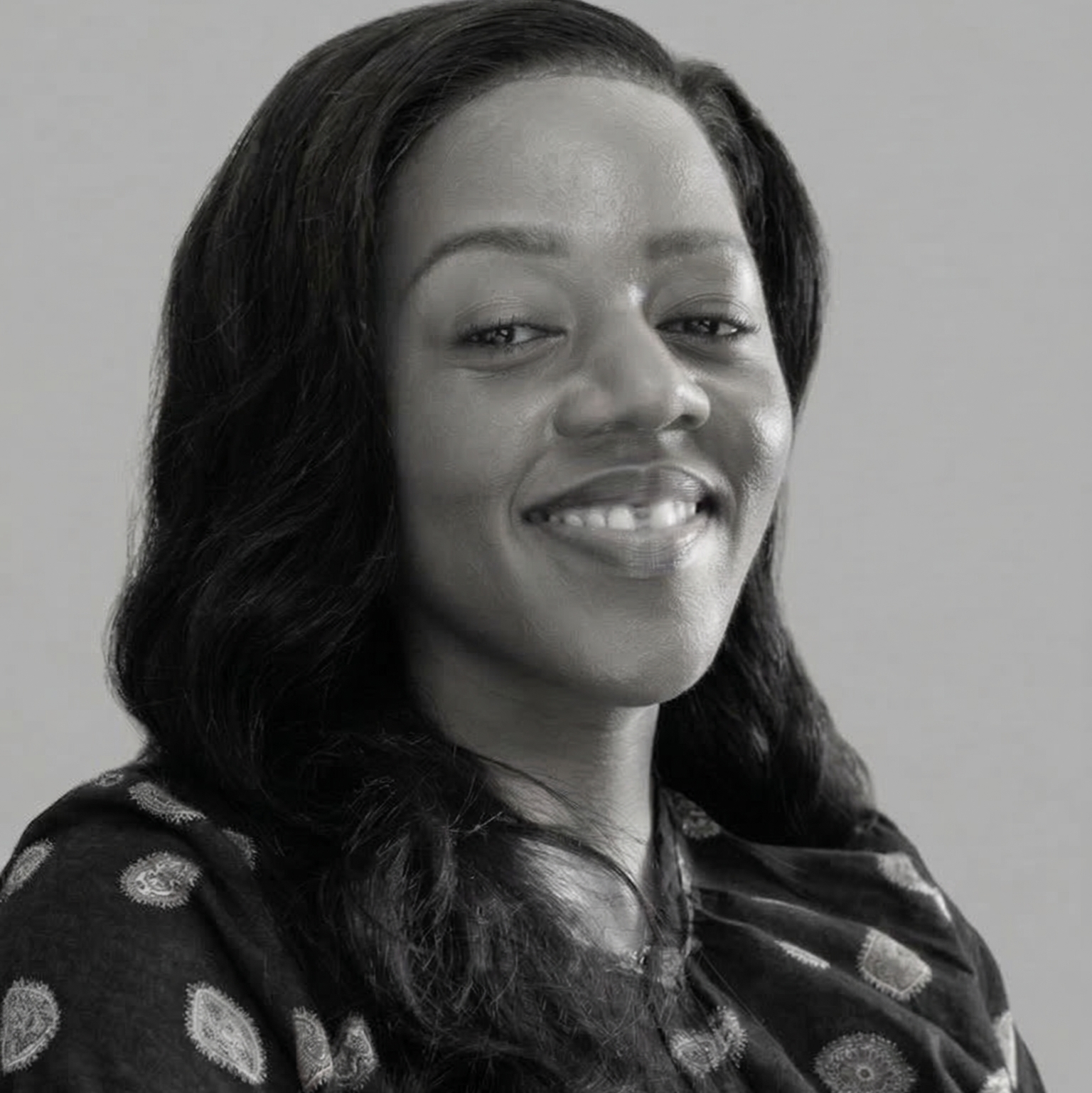 Black and white portrait of Dr. Zakhona Ngema, Founder of MediVtal Health Supplements South Africa, a female with a patterned top against a plain background
